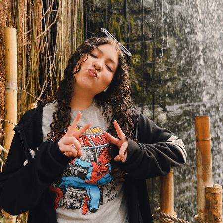 My sister Alli posing in front of waterfall at the zoo