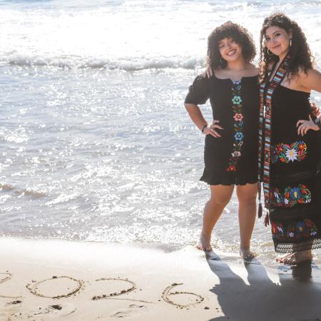 AJ and Alli at the beach with 2026 written on the sand