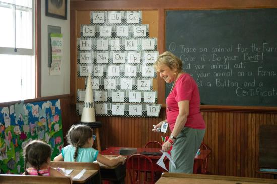 teacher smiling at student to the left